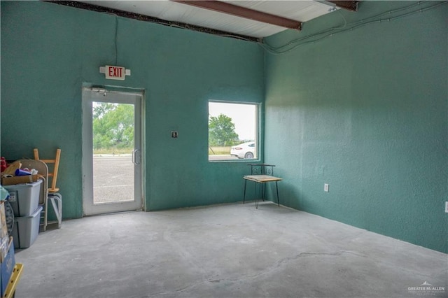 empty room with concrete flooring and a wealth of natural light