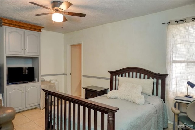 tiled bedroom with a textured ceiling and ceiling fan