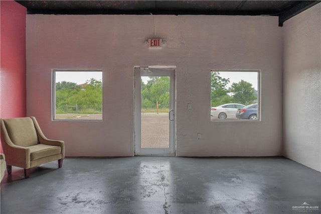 doorway to outside featuring concrete floors