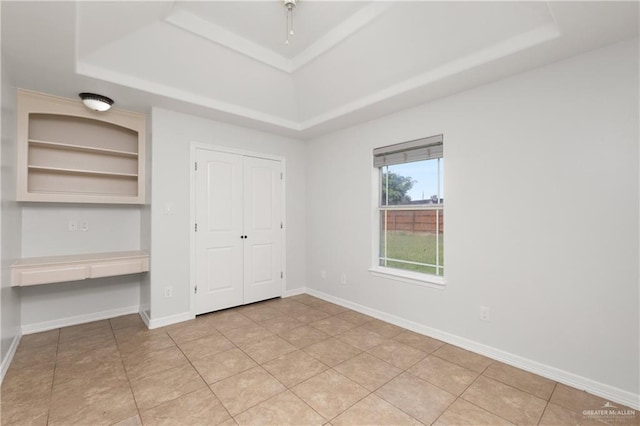 4113 Ulex Ave, Mcallen, TX 78504 - unfurnished bedroom featuring a tray ceiling, light tile patterned floors, a closet, and baseboards