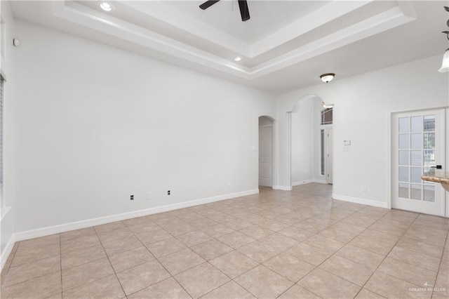 4113 Ulex Ave, Mcallen, TX 78504 - empty room with arched walkways, a tray ceiling, a ceiling fan, and recessed lighting