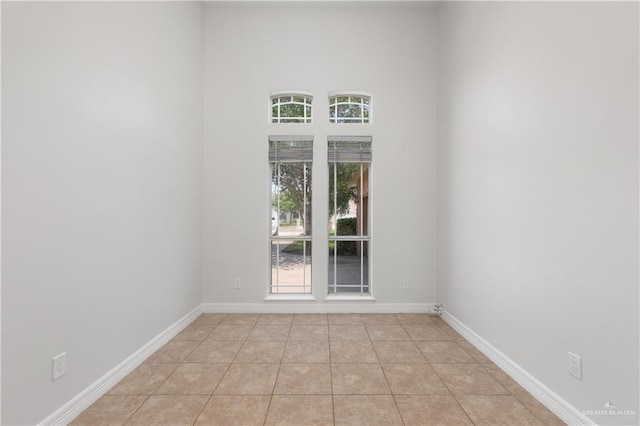 4113 Ulex Ave, Mcallen, TX 78504 - unfurnished room featuring light tile patterned floors, baseboards, and a towering ceiling
