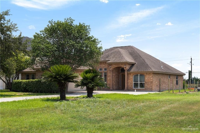 4113 Ulex Ave, Mcallen, TX 78504 - french country home featuring brick siding, a front yard, and driveway