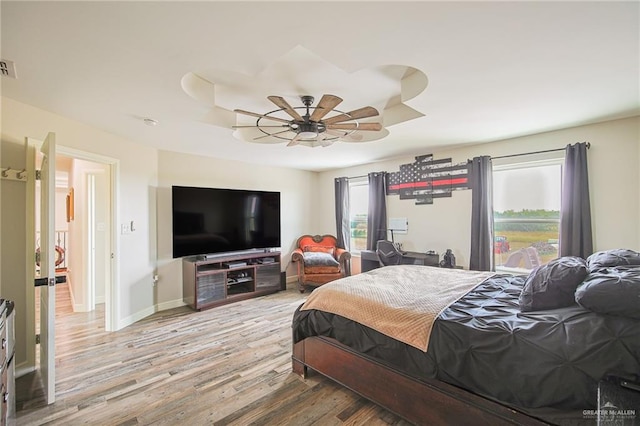 bedroom featuring hardwood / wood-style flooring and ceiling fan