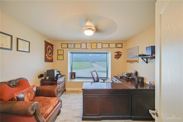 home office with ceiling fan and light wood-type flooring