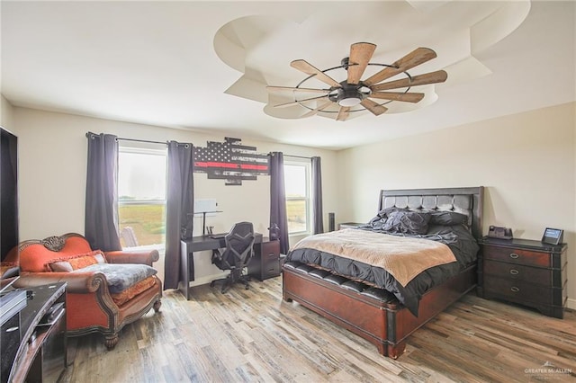 bedroom with hardwood / wood-style flooring and ceiling fan