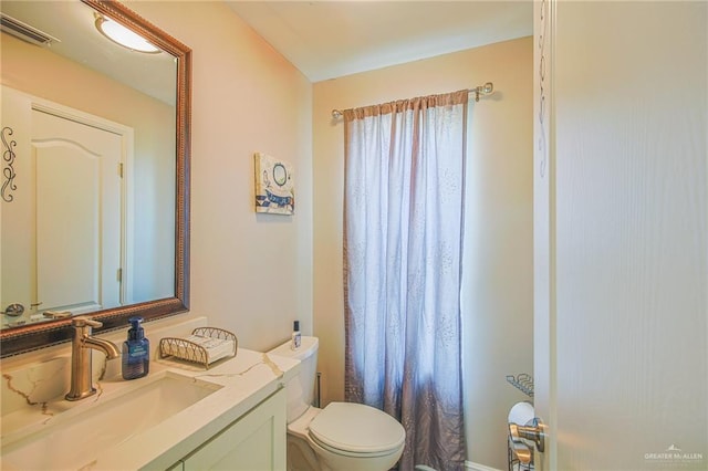 bathroom featuring vanity and toilet