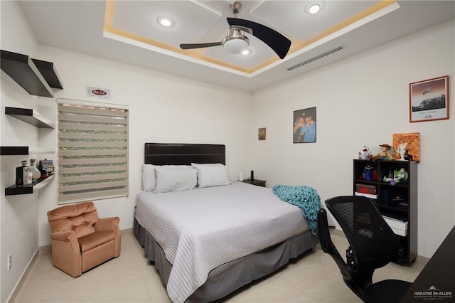 bedroom with ceiling fan, light tile patterned flooring, recessed lighting, visible vents, and a raised ceiling