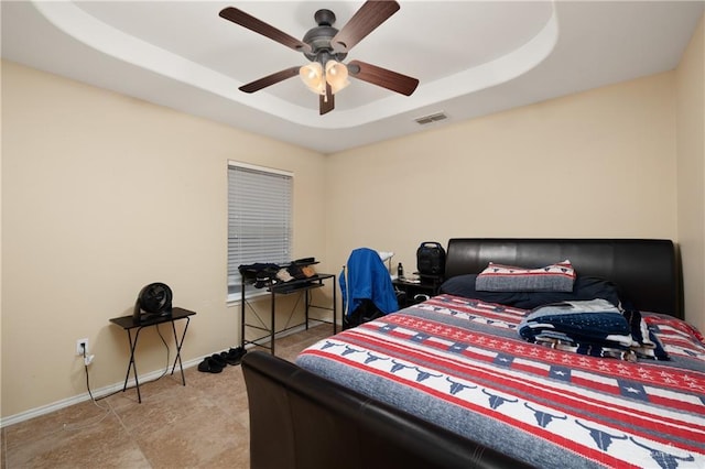 bedroom featuring a tray ceiling and ceiling fan