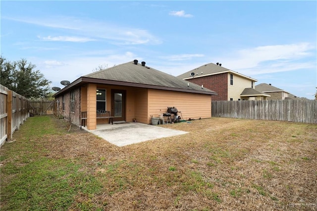 rear view of property with a lawn and a patio area