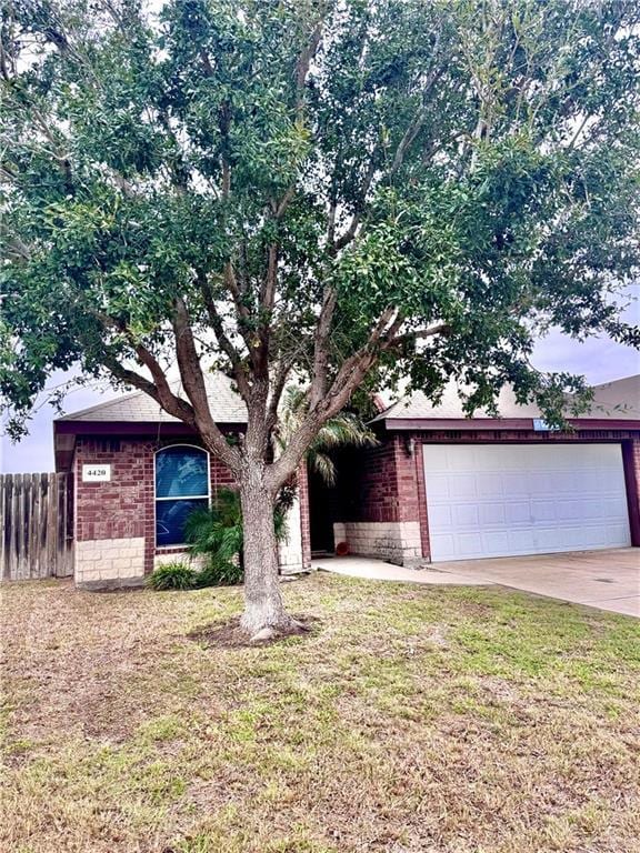 ranch-style home with a garage and a front yard