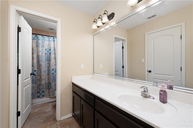 bathroom featuring walk in shower, vanity, and tile patterned flooring