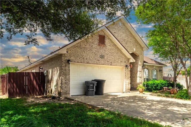 property exterior at dusk featuring a garage