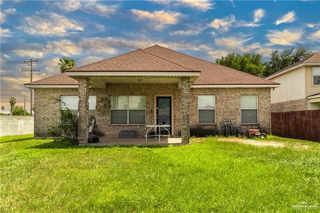 rear view of house featuring a yard and a patio area