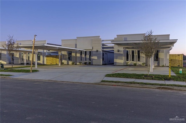 outdoor building at dusk featuring a carport