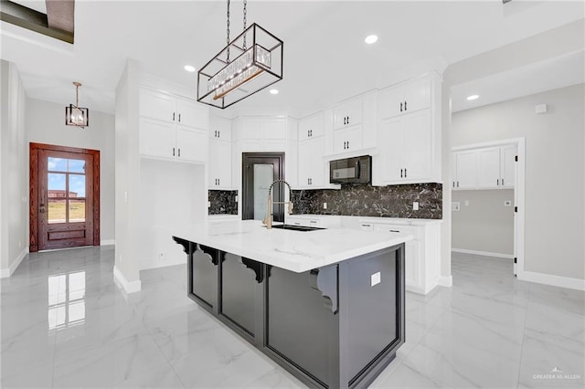 2313 Blue Sky Dr, Weslaco, TX 78599 - kitchen with black microwave, decorative backsplash, light marble finish floors, and recessed lighting