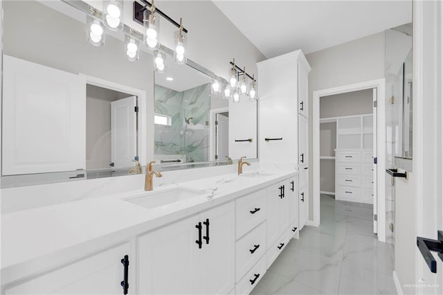 2313 Blue Sky Dr, Weslaco, TX 78599 - bathroom featuring a marble finish shower, double vanity, marble finish floors, and a spacious closet