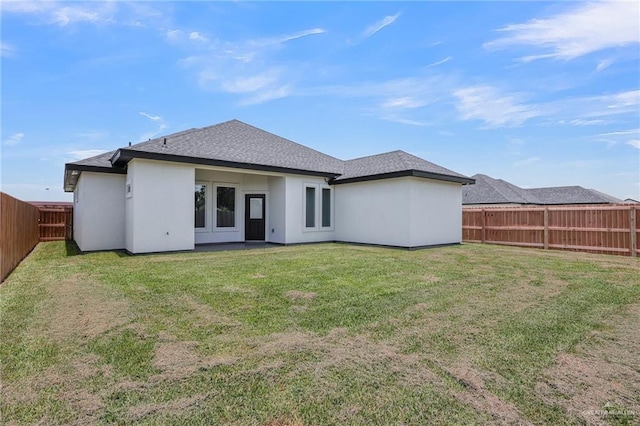 2313 Blue Sky Dr, Weslaco, TX 78599 - rear view of house with a fenced backyard, a shingled roof, and stucco siding