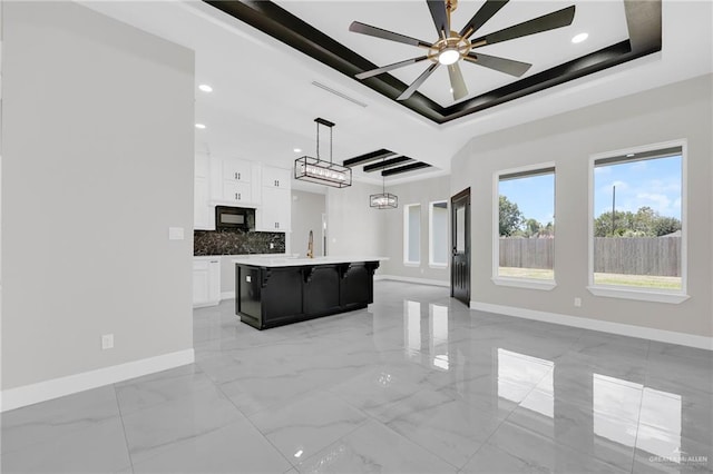 2313 Blue Sky Dr, Weslaco, TX 78599 - unfurnished living room with a raised ceiling, a ceiling fan, light marble finish floors, and recessed lighting