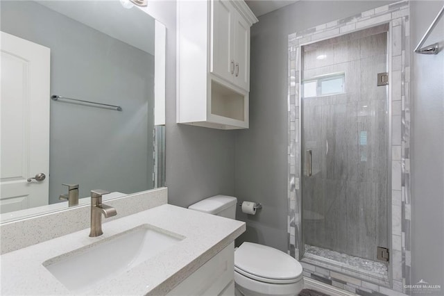 bathroom featuring vanity, toilet, and walk in shower