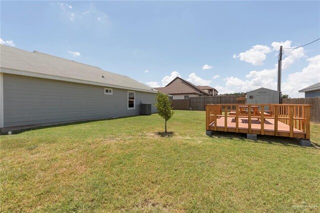 view of yard featuring central AC and a wooden deck