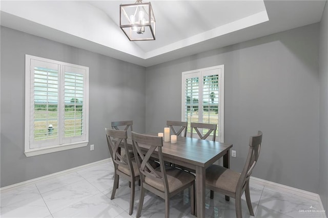 dining area with a tray ceiling