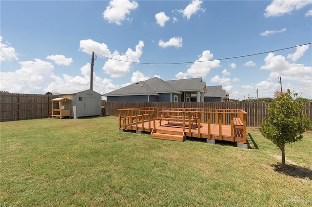 rear view of house with a storage shed, a yard, and a wooden deck