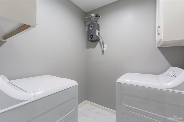 washroom featuring cabinets and independent washer and dryer