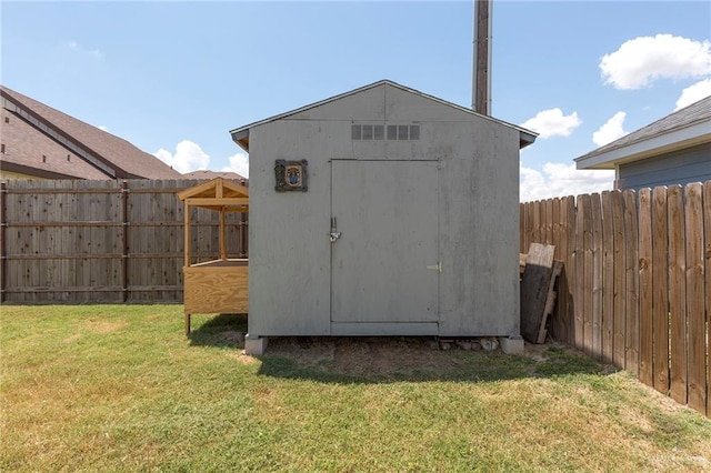 view of outbuilding featuring a yard