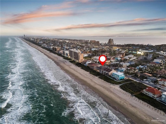 drone / aerial view with a water view and a beach view