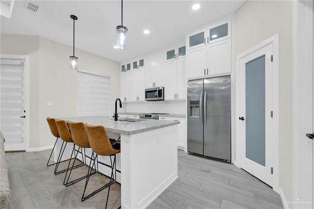 1409 E Danielle Ave E, Pharr, TX 78577 - kitchen with a kitchen breakfast bar, a kitchen island with sink, visible vents, appliances with stainless steel finishes, and a sink