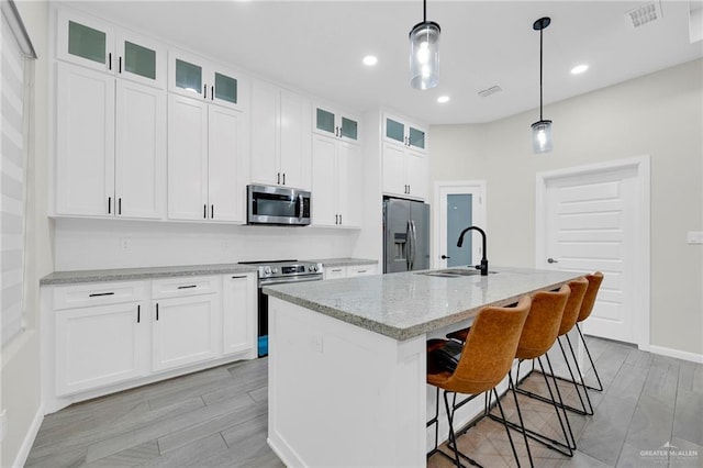 1409 E Danielle Ave E, Pharr, TX 78577 - kitchen featuring a sink, appliances with stainless steel finishes, white cabinets, and visible vents