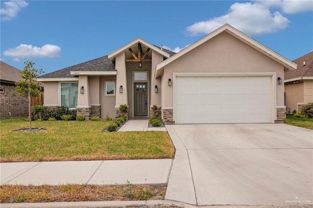 1409 E Danielle Ave E, Pharr, TX 78577 - view of front of property with a garage, stucco siding, driveway, and stone siding
