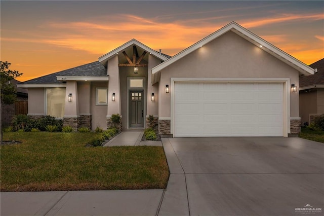 1409 E Danielle Ave E, Pharr, TX 78577 - view of front of home featuring an attached garage, stucco siding, and stone siding