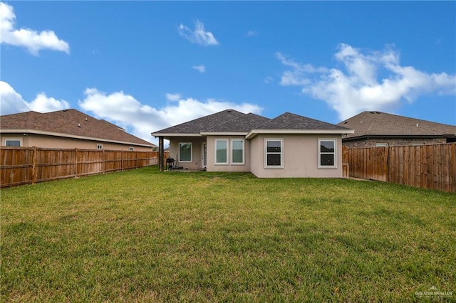 1409 E Danielle Ave E, Pharr, TX 78577 - back of property with a lawn, a fenced backyard, and stucco siding