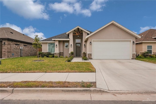 1409 E Danielle Ave E, Pharr, TX 78577 - view of front of property featuring a garage, a front yard, stone siding, stucco siding, and concrete driveway