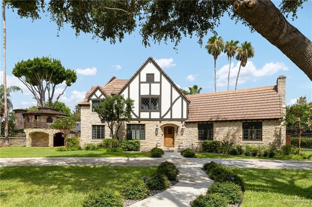 707 N 15th St, Mcallen, TX 78501 - tudor house with stone siding and a front yard