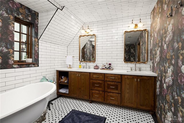 707 N 15th St, Mcallen, TX 78501 - bathroom with a soaking tub, double vanity, and tile walls