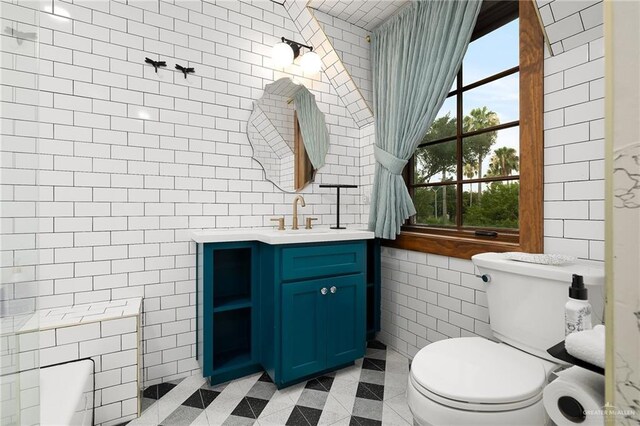 707 N 15th St, Mcallen, TX 78501 - bathroom with tile walls, vanity, and tile patterned flooring