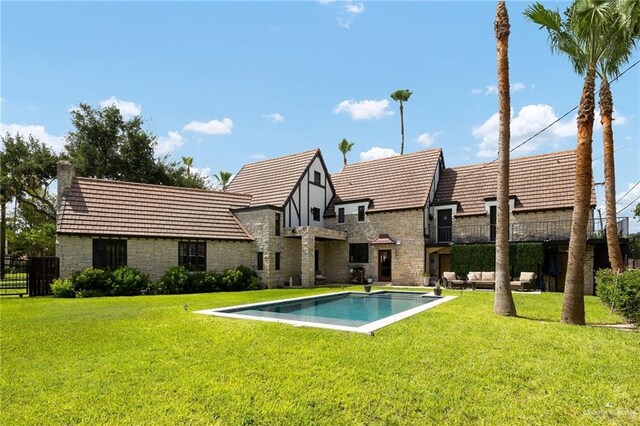 707 N 15th St, Mcallen, TX 78501 - back of house with stone siding, an outdoor living space, and a chimney