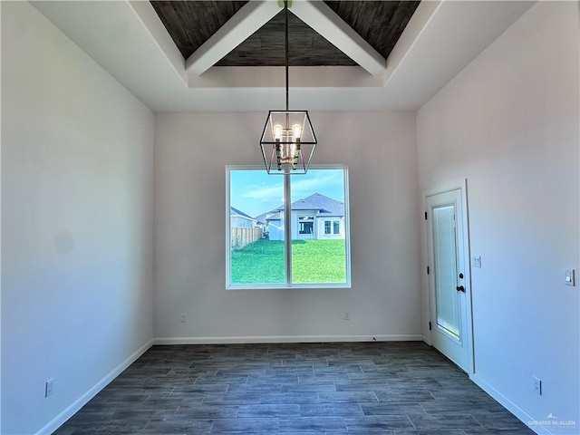 unfurnished dining area with an inviting chandelier, baseboards, dark wood-type flooring, and a tray ceiling
