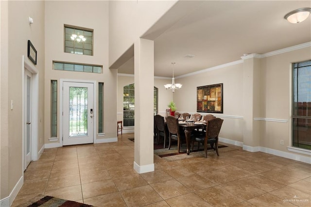 tiled foyer entrance with a notable chandelier and ornamental molding