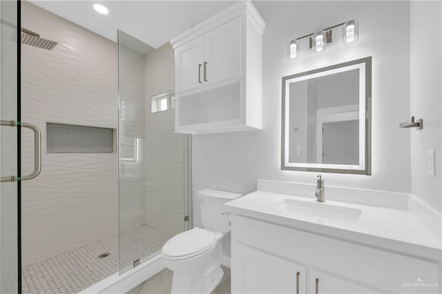 bathroom with vanity, toilet, and walk in shower