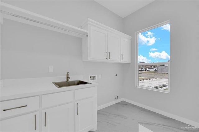 clothes washing area with sink, cabinets, hookup for a washing machine, a healthy amount of sunlight, and hookup for an electric dryer