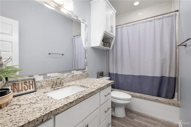 1012 Cooper Ln, San Juan, TX 78589 - bathroom featuring vanity, toilet, wood finished floors, and recessed lighting