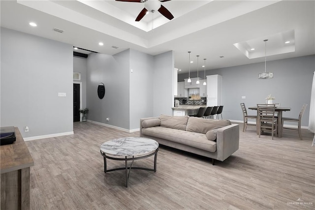 1012 Cooper Ln, San Juan, TX 78589 - living room featuring a raised ceiling, ceiling fan, recessed lighting, and light wood-style flooring