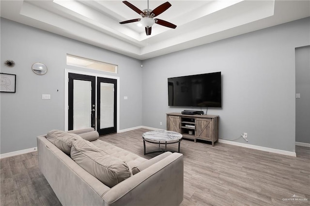 1012 Cooper Ln, San Juan, TX 78589 - living room featuring ceiling fan, a tray ceiling, wood finished floors, and baseboards