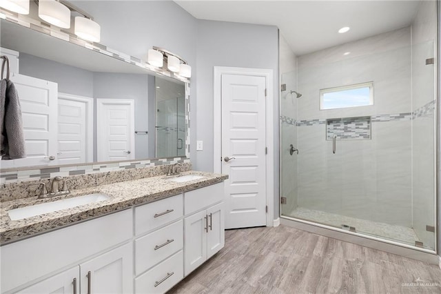 1012 Cooper Ln, San Juan, TX 78589 - full bathroom featuring a stall shower, wood finished floors, double vanity, and recessed lighting