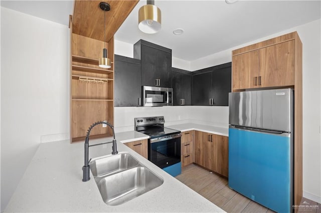 kitchen with open shelves, stainless steel appliances, light countertops, a sink, and dark cabinetry