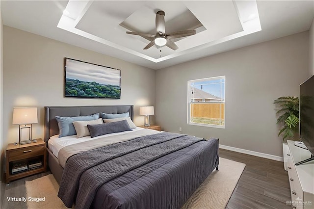 2200 Zinnia St, Weslaco, TX 78599 - bedroom featuring a tray ceiling, wood finished floors, and a ceiling fan
